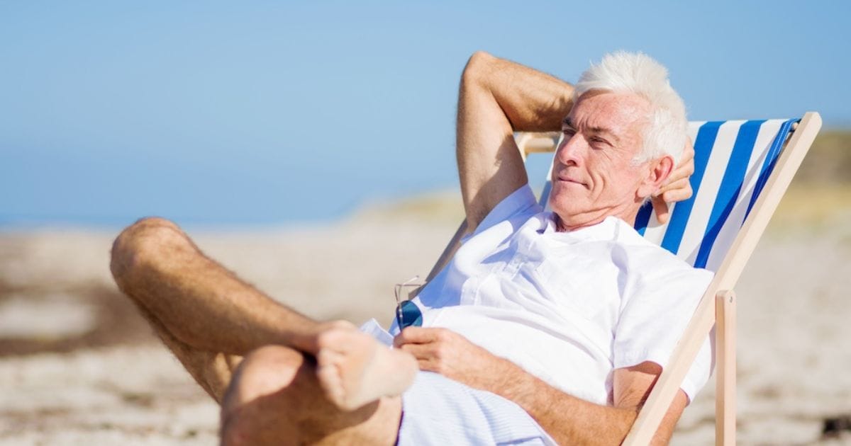 uomo si abbronza al mare