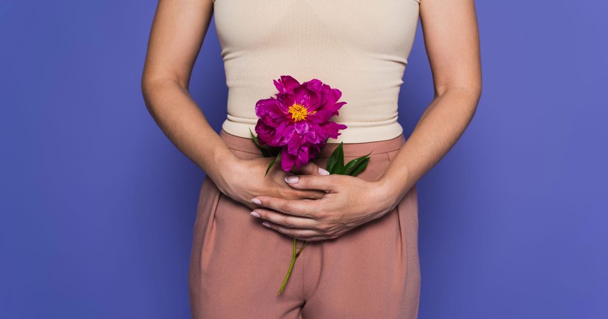 donna tiene un mazzo di fiori all'altezza delle parti intime a indicare il periodo della premenopausa